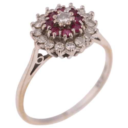 1389 - An 18ct gold ruby and diamond cluster ring, set with round-cut rubies and modern round brilliant-cut... 