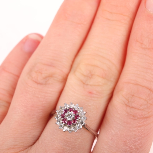 1389 - An 18ct gold ruby and diamond cluster ring, set with round-cut rubies and modern round brilliant-cut... 