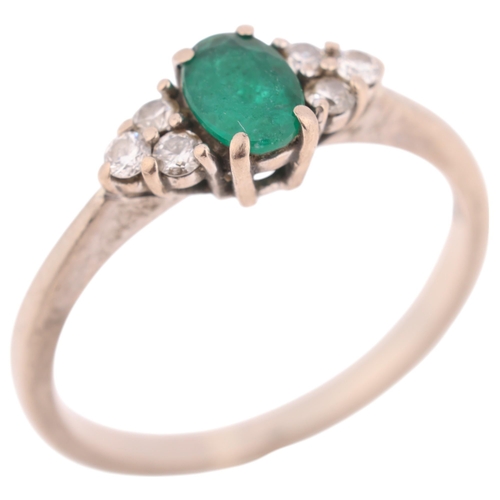 1394 - An 18ct white gold emerald and diamond ring, maker SFJ, London 2013, claw set with oval mixed-cut em... 