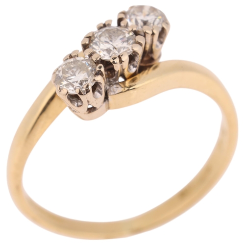 1399 - An 18ct gold three stone diamond crossover ring, claw set with modern round brilliant-cut diamonds, ... 