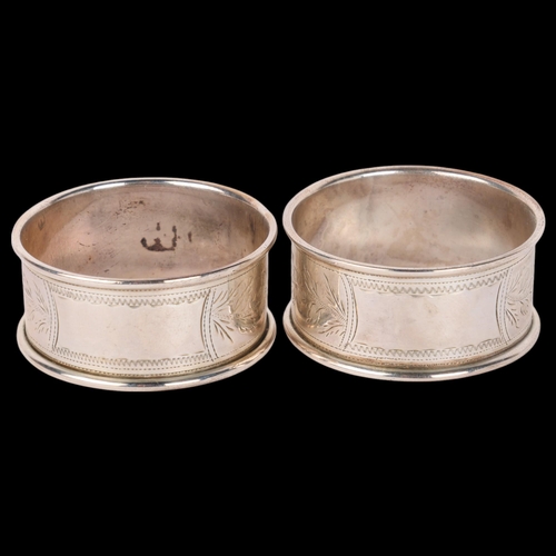 1647 - A cased pair of George V silver napkin rings, Joseph Gloster Ltd, Birmingham 1920, floral engraved d... 