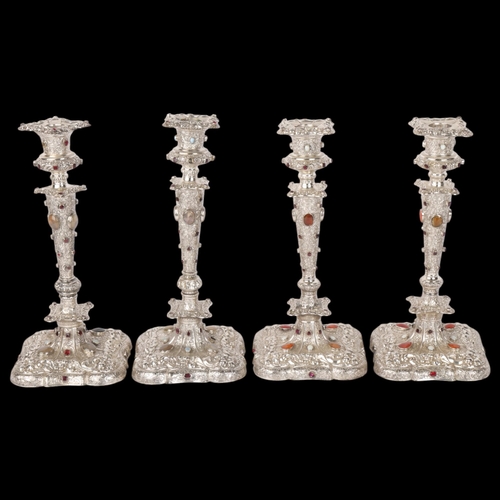 1653 - A set of 4 Austrian gem set silver table candlesticks, Vienna circa 1859, allover relief embossed fo... 