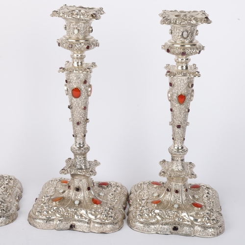 1653 - A set of 4 Austrian gem set silver table candlesticks, Vienna circa 1859, allover relief embossed fo... 