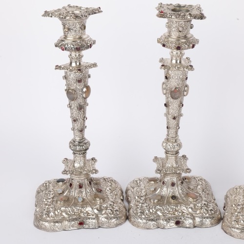 1653 - A set of 4 Austrian gem set silver table candlesticks, Vienna circa 1859, allover relief embossed fo... 