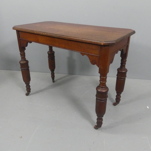 2116 - A Victorian style oak writing table, with baluster turned legs and brass casters. Width 98cm, height... 