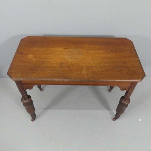 2116 - A Victorian style oak writing table, with baluster turned legs and brass casters. Width 98cm, height... 