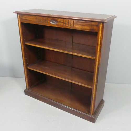 2118 - A mahogany and satinwood strung open bookcase, with two adjustable shelves and carved decoration. Wi... 