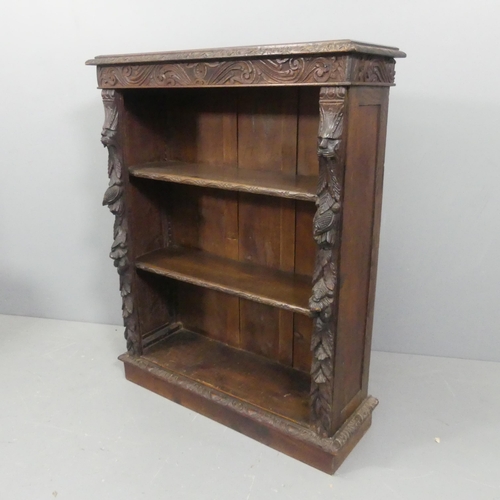 2119 - A Victorian carved oak open bookcase, with carved Green Man and foliate design. Width 90cm, height 1... 