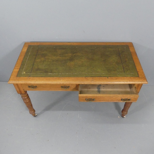 2123 - A Victorian oak 2 drawer writing desk with tooled and embossed green leather writing surface. W124cm... 