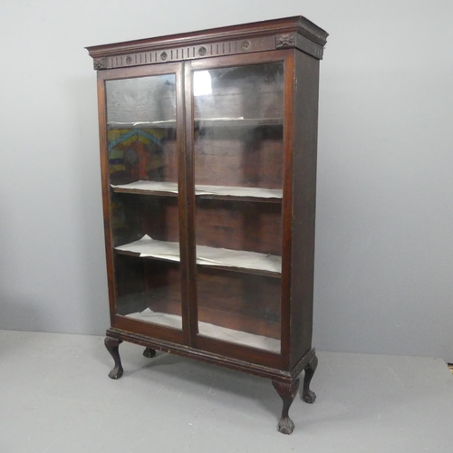 2131 - An early 20th century oak display cabinet, with two glazed doors, shelved interior and raised on cab... 