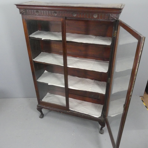 2131 - An early 20th century oak display cabinet, with two glazed doors, shelved interior and raised on cab... 