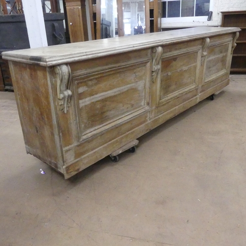 2163 - A Victorian pine pine shop counter, with panelled front and shelved reverse. Length 293cm, height 78... 