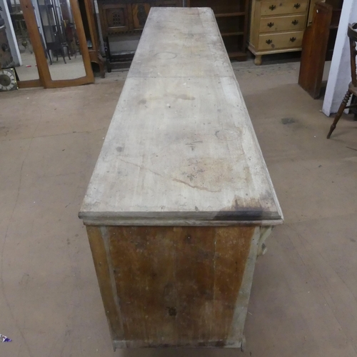 2163 - A Victorian pine pine shop counter, with panelled front and shelved reverse. Length 293cm, height 78... 