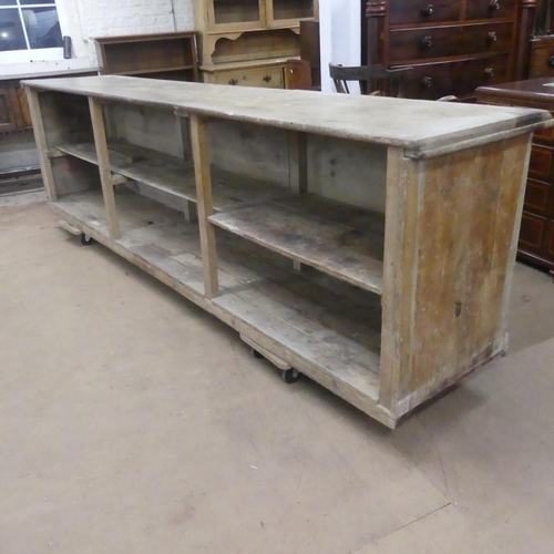 2163 - A Victorian pine pine shop counter, with panelled front and shelved reverse. Length 293cm, height 78... 