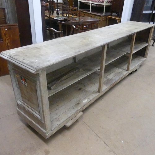 2163 - A Victorian pine pine shop counter, with panelled front and shelved reverse. Length 293cm, height 78... 