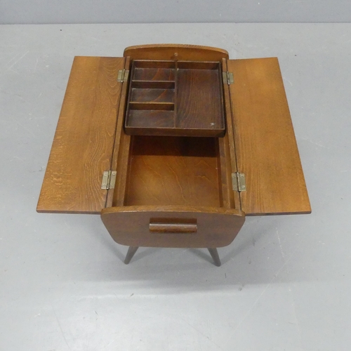 2165 - A mid-century oak sewing cabinet. Width 49cm, height 46cm, depth 28cm.