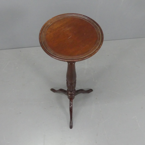 2168 - A mahogany jardinière stand, on turned central column with tripod base. Height 92cm.