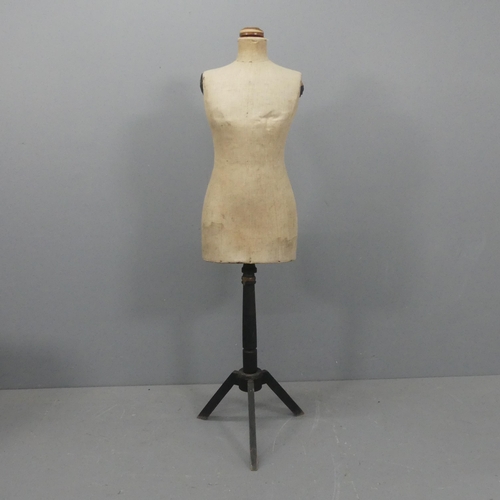 2169 - A vintage shop display mannequin, mounted on painted tripod base and labelled for Stockman's. Height... 