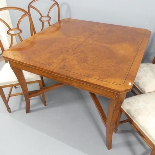 2173 - A modern burr-walnut veneered and ebony strung draw-leaf dining table, with x-shaped stretcher and f... 