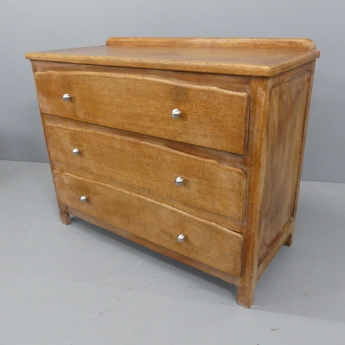 2176 - A 1930s oak chest of three long drawers. Width 110cm, height 88cm, depth 49cm.