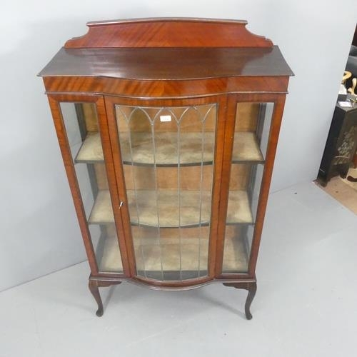 2182 - A 1930s mahogany display cabinet, with raised back, lattice glazed door and raised on cabriole legs.... 