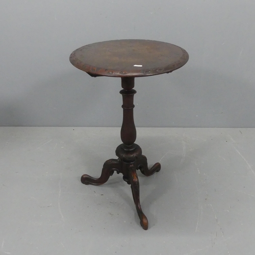 2186 - An oak and mahogany oval tilt-top occasional table, with carved decoration and raised on turned cent... 