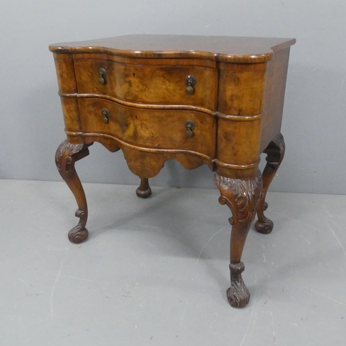 2201 - A George II style cross-banded walnut lowboy serpentine chest of two drawers raised on carved cabrio... 