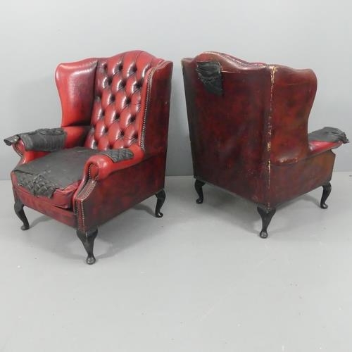 2204 - A pair of modern red button-back and studded leather upholstered Chesterfield style wingback firesid... 