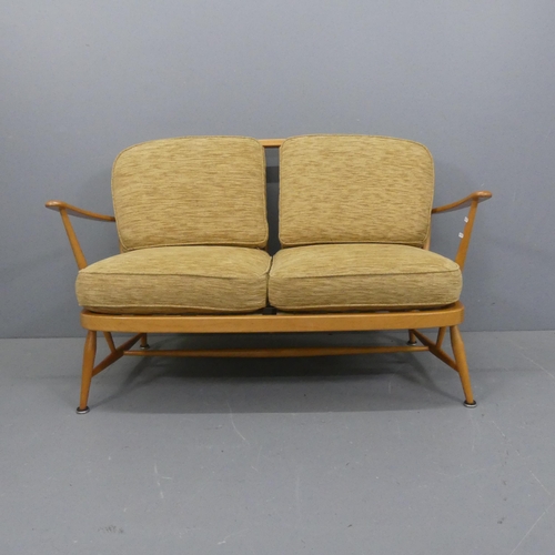 2010 - ERCOL - A mid-century design beech model 204 two-seater sofa, with upholstered cushions and gold mak... 