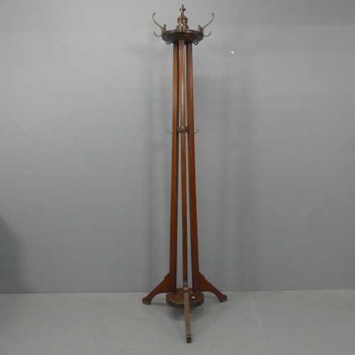 2212 - A Victorian Arts & Crafts mahogany hall stand, with rotating coat hooks, fluted decoration and tripo... 