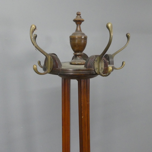 2212 - A Victorian Arts & Crafts mahogany hall stand, with rotating coat hooks, fluted decoration and tripo... 