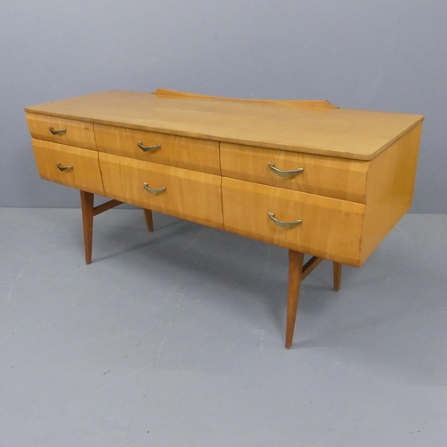 2220 - A mid-century maple veneered sideboard, with six drawers and teak legs, in the manner of Meredew. Wi... 