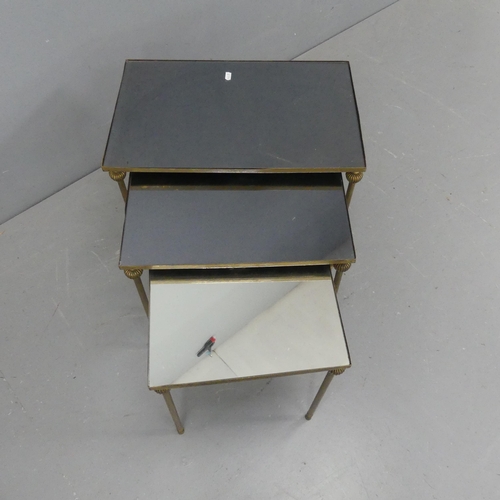 2074 - A set of 3 nesting brass tables, with inset mirrored tops, in thr manner of Maison Jansen. Largest W... 