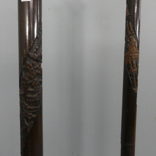 2242 - Two similar oriental carved oak standard lamps. Height to bayonet 161cm.