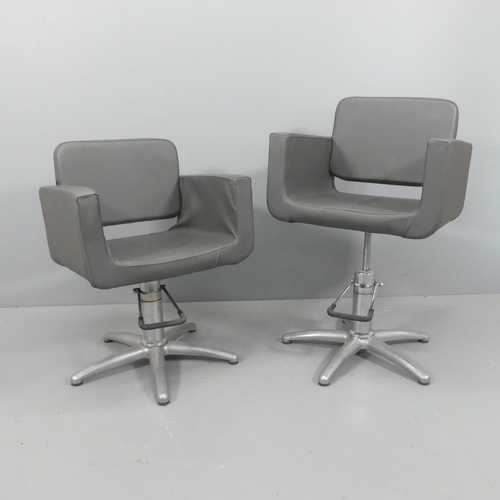 2251 - A pair of modern swivel barber's chairs, with rise and fall mechanism and removable washable covers.