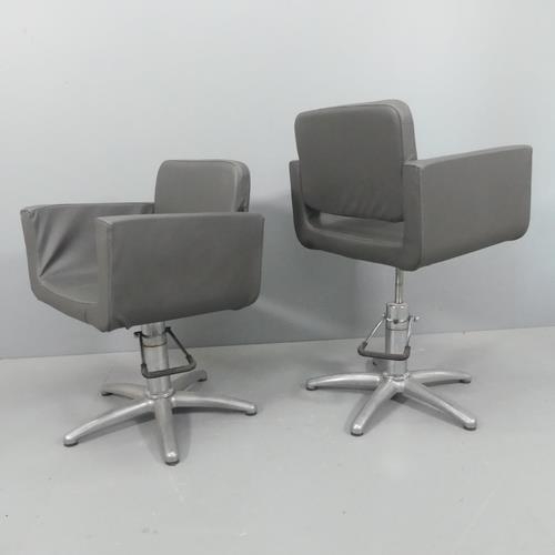 2251 - A pair of modern swivel barber's chairs, with rise and fall mechanism and removable washable covers.