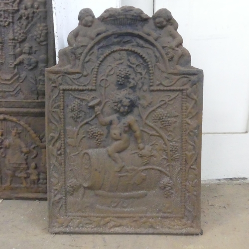 2254 - A 18th century cast iron fireback, with classical cherub design and dated 1801. Width 47cm, height 6... 