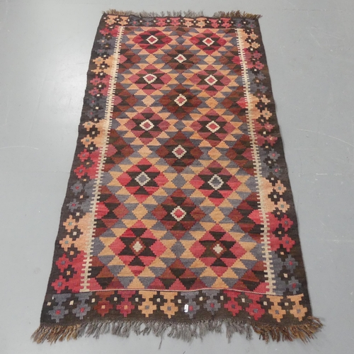 2272 - A red-ground hand knotted Kilim rug. Length 173cm, width 92cm.