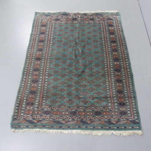 2273 - A green-ground Afghan rug. Length 173cm, width 130cm.