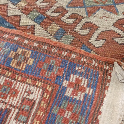 2274 - A cream and blue-ground Kazak rug. Length 200cm, width 125cm.