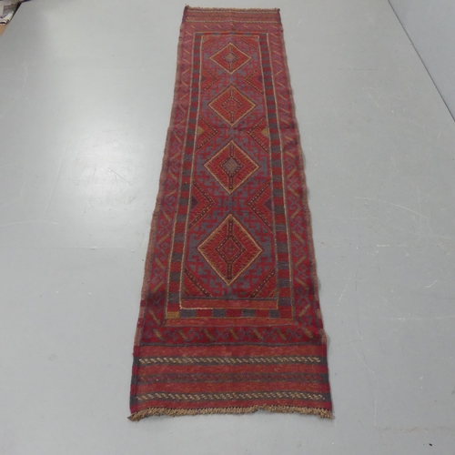 2288 - A red-ground Meshwani Runner. Length 252cm, width 60cm.