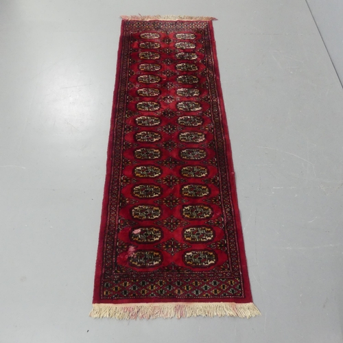 2292 - A red ground Bokhara runner. length 190cm, width 64cm.