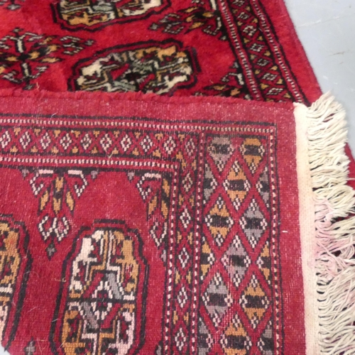 2292 - A red ground Bokhara runner. length 190cm, width 64cm.