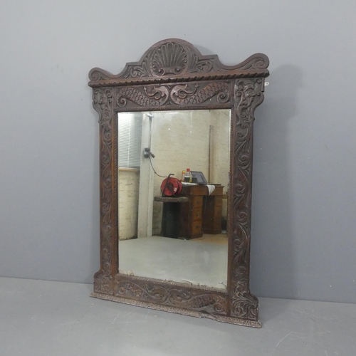 2296 - A 19th century oak-framed over-mantel bevel-edged mirror with carved decoration. Width 102cm, height... 