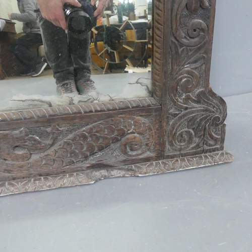 2296 - A 19th century oak-framed over-mantel bevel-edged mirror with carved decoration. Width 102cm, height... 