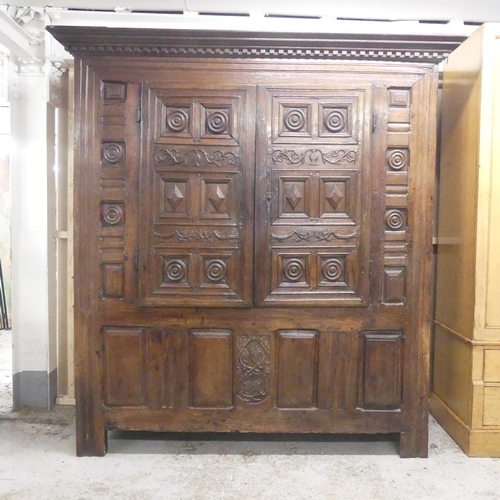 2508 - A 17th century and later panelled oak larder cupboard, with two doors revealing a shelf fitted inter... 