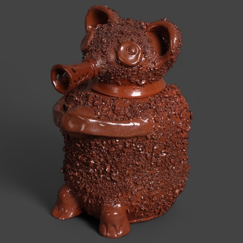 142 - A Staffordshire style glazed terracotta brown bear jar with impressed mark to base, height 23cm.