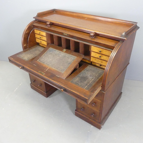 2561 - A 19th century twin-pedestal cylinder-top desk, with fitted interior and six drawers. Overall width ... 