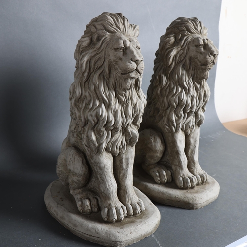 787 - A pair of concrete garden statues, seated Lions, height 40cm.