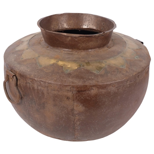 820 - A panelled steel pot with ring handles and brass decoration, 37cm across